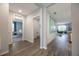 Hallway with wood flooring, leading to a bedroom/office, laundry, and living area at 746 Mocking Jay Ln, St Cloud, FL 34771