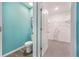 Open doorway to a bathroom and walk-in closet, featuring a toilet, and closet shelving at 746 Mocking Jay Ln, St Cloud, FL 34771