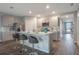 Modern kitchen featuring an island with bar seating, stainless steel appliances, and sleek cabinetry at 746 Mocking Jay Ln, St Cloud, FL 34771