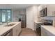 Charming kitchen with stainless steel appliances, gray cabinets, an island, and plenty of counter space at 746 Mocking Jay Ln, St Cloud, FL 34771