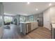 Open concept kitchen with a large island, stainless steel appliances, and ample cabinet space at 746 Mocking Jay Ln, St Cloud, FL 34771