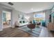 Bright living room with stylish furniture, a large window, and an open doorway to the main bedroom at 746 Mocking Jay Ln, St Cloud, FL 34771