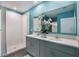 Modern bathroom features a double vanity, large mirror, and white tiled shower at 746 Mocking Jay Ln, St Cloud, FL 34771