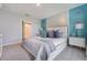 Stylish main bedroom with decorative pillows, artwork, and a bright, neutral color palette at 746 Mocking Jay Ln, St Cloud, FL 34771