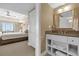Beautiful bathroom with granite countertops, white cabinets, and an open view into the bedroom at 7593 Gathering Dr # 502, Reunion, FL 34747