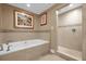Elegant bathroom with a soaking tub and a separate glass-enclosed shower at 7593 Gathering Dr # 502, Reunion, FL 34747