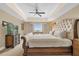 Comfortable bedroom with a luxurious bed, dresser, ceiling fan, and a view from the window at 7593 Gathering Dr # 502, Reunion, FL 34747