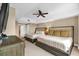 Inviting bedroom with two beds, side tables, ceiling fan, and a neutral color scheme at 7593 Gathering Dr # 502, Reunion, FL 34747