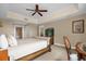 Bedroom featuring a large bed, ceiling fan, and a desk in front of the window at 7593 Gathering Dr # 502, Reunion, FL 34747