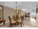 This dining area includes chandelier, large wall mirror, and easy access to the living room and outdoor balcony at 7593 Gathering Dr # 502, Reunion, FL 34747