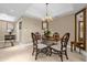 The dining area offers a unique glass-topped dining table with wood chairs, and a decorative chandelier at 7593 Gathering Dr # 502, Reunion, FL 34747