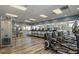 Well-equipped fitness center with modern machines, large windows, and wood-look flooring at 7593 Gathering Dr # 502, Reunion, FL 34747