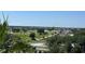 Scenic view of a lush green golf course and neighboring homes under a clear sky at 7593 Gathering Dr # 502, Reunion, FL 34747