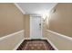 Inviting hallway with neutral wall paint, crown molding, and a decorative area rug leading to the main door at 7593 Gathering Dr # 502, Reunion, FL 34747