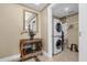 Convenient laundry room with stacked washer and dryer, storage shelves, and a stylish accent table at 7593 Gathering Dr # 502, Reunion, FL 34747