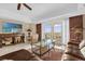 Relaxing living room featuring a comfortable sofa, glass table, and sliding doors to a balcony at 7593 Gathering Dr # 502, Reunion, FL 34747