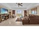 Comfortable living room features outdoor balcony access, ceiling fan, and comfortable furniture at 7593 Gathering Dr # 502, Reunion, FL 34747