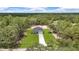 Stunning aerial view of a modern home surrounded by lush greenery and a long driveway at 8202 Sw 123Rd Ter, Dunnellon, FL 34432