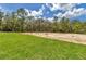 Large backyard with a combination of grass and sand at 8202 Sw 123Rd Ter, Dunnellon, FL 34432