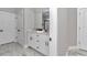 Bright bathroom with a double sink vanity and stone tile floors at 8202 Sw 123Rd Ter, Dunnellon, FL 34432