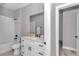 Bright bathroom with a white vanity, shower-tub combination, and neutral decor at 8202 Sw 123Rd Ter, Dunnellon, FL 34432