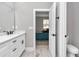 Well-lit bathroom with white cabinets, modern hardware, and a view of the bedroom at 8202 Sw 123Rd Ter, Dunnellon, FL 34432