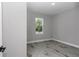 Neutral bedroom with wood-look floors and a view of the outdoors at 8202 Sw 123Rd Ter, Dunnellon, FL 34432