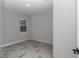 This bedroom features wood-style flooring and a window overlooking the outdoors at 8202 Sw 123Rd Ter, Dunnellon, FL 34432