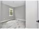 Bright bedroom with wood-look tile flooring, a window, and a neutral color palette at 8202 Sw 123Rd Ter, Dunnellon, FL 34432