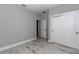 Simple bedroom featuring tile flooring, baseboard trim, and a sliding door closet at 8202 Sw 123Rd Ter, Dunnellon, FL 34432