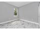 Bright bedroom with wood-look tile flooring, a window, and a neutral color palette at 8202 Sw 123Rd Ter, Dunnellon, FL 34432