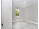 Bright bedroom featuring wood-look tile flooring and a large window with a scenic view at 8202 Sw 123Rd Ter, Dunnellon, FL 34432