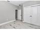 Spacious bedroom featuring wood-look tile flooring, closet, and natural light at 8202 Sw 123Rd Ter, Dunnellon, FL 34432