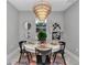 This dining room features a decorative chandelier and outdoor views at 8202 Sw 123Rd Ter, Dunnellon, FL 34432