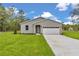 Charming home with a manicured lawn and white garage door at 8202 Sw 123Rd Ter, Dunnellon, FL 34432