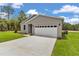 Home with a two car garage, lawn, and landscaping at 8202 Sw 123Rd Ter, Dunnellon, FL 34432