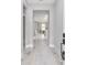 Inviting hallway featuring light wood floors leading to a sunlit living area at 8202 Sw 123Rd Ter, Dunnellon, FL 34432
