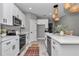 This open-concept kitchen has quartz countertops and stainless steel appliances at 8202 Sw 123Rd Ter, Dunnellon, FL 34432