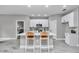 Modern kitchen with white cabinetry, a center island, and stylish seating at 8202 Sw 123Rd Ter, Dunnellon, FL 34432
