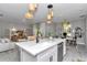 This open-concept kitchen has quartz countertops and stainless steel appliances at 8202 Sw 123Rd Ter, Dunnellon, FL 34432