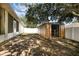 Fenced backyard with shade trees and outdoor storage shed at 9532 Water Fern Cir, Clermont, FL 34711