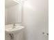Pedestal sink in a half bathroom with neutral paint at 9532 Water Fern Cir, Clermont, FL 34711