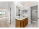 This bathroom features a double sink vanity, tile floors, and recessed lighting at 9532 Water Fern Cir, Clermont, FL 34711