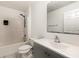 This bathroom features a shower-tub combo, toilet, gray vanity, and sink at 9532 Water Fern Cir, Clermont, FL 34711