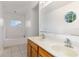This bathroom has tile floors, a soaking tub, and a dual sink vanity at 9532 Water Fern Cir, Clermont, FL 34711