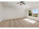 This bedroom has neutral carpet, natural light, and a ceiling fan at 9532 Water Fern Cir, Clermont, FL 34711