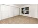 Cozy bedroom featuring three-door closet and large window at 9532 Water Fern Cir, Clermont, FL 34711
