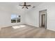 This bedroom has neutral carpet, natural light, and a ceiling fan at 9532 Water Fern Cir, Clermont, FL 34711