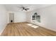 Bedroom with wood floors, a ceiling fan, and a window with a view of the pool at 9532 Water Fern Cir, Clermont, FL 34711