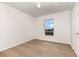 This bedroom features neutral carpeting, a window, and ample natural light at 9532 Water Fern Cir, Clermont, FL 34711
